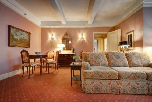 Living Room of the Grand King Suite at the Hotel Elysee in NYC.  Features a small dining table and a kitchenette.