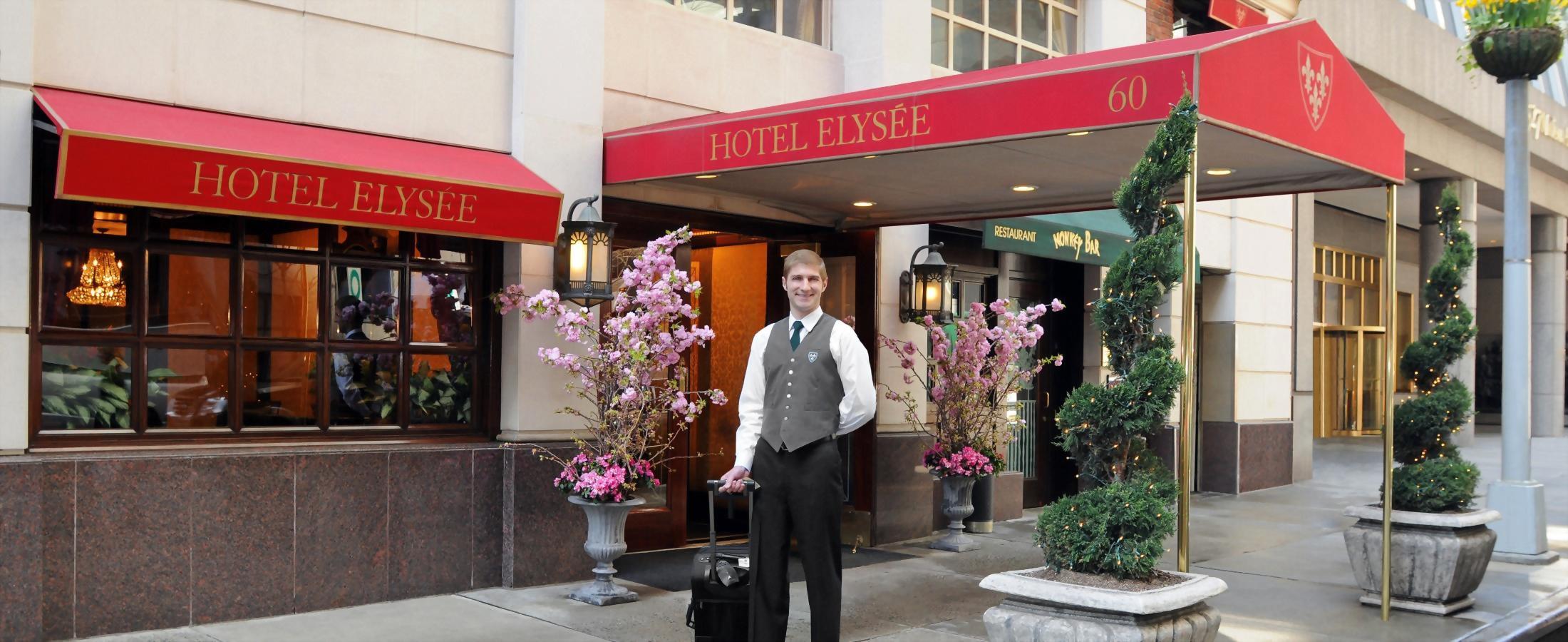 bellman greeting a guest at main entrance of Hotel Elysee