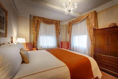 Bedroom of the Grand King Suite.  All rooms are front facing and the bedrooms each have 2 windows to allow for plenty of sunlight.