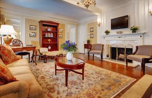 The living room of the Presidential Suite honoring Tennessee Williams is adorned with memorabilia of the brilliant playwright a flat panel television and a non-working fireplace.